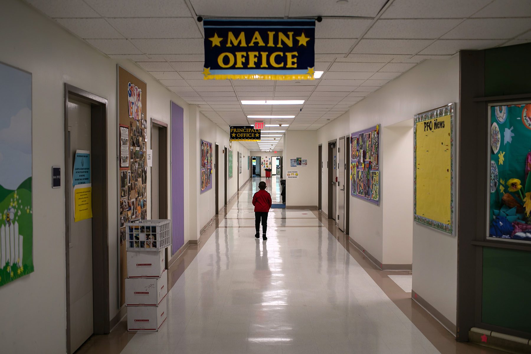 A child walks through the halls between classes.