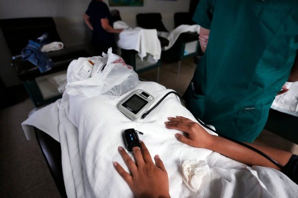 Nurses check women's vitals as they lay down before, or after their abortions.