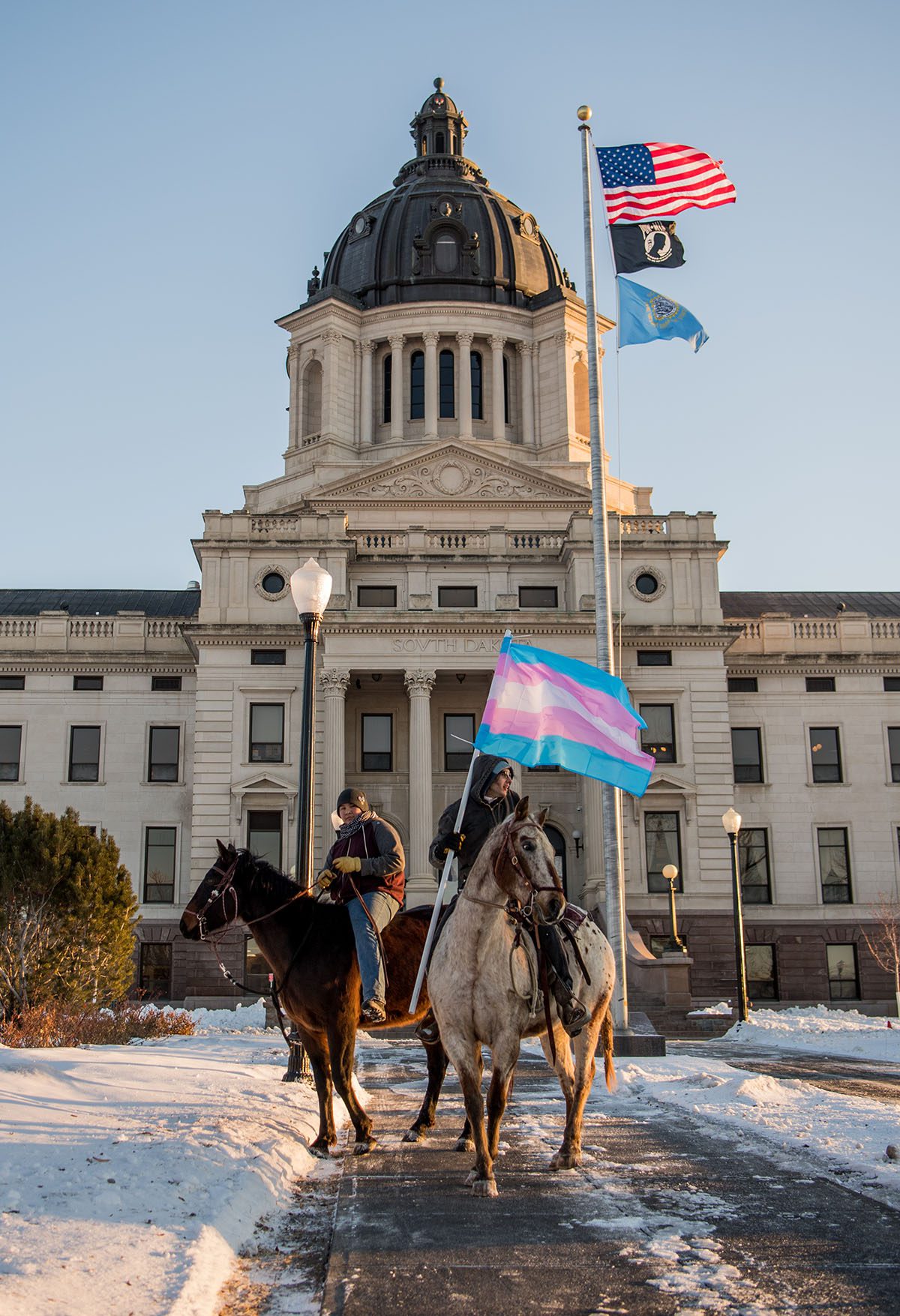 Demonstrators on horses oppose anti-trans legislation near the South Dakota Capitol.