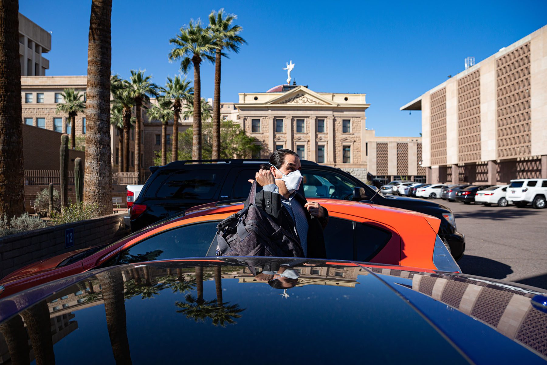 Sen. Mendez wears a mask as he gets out of his car to go to work.