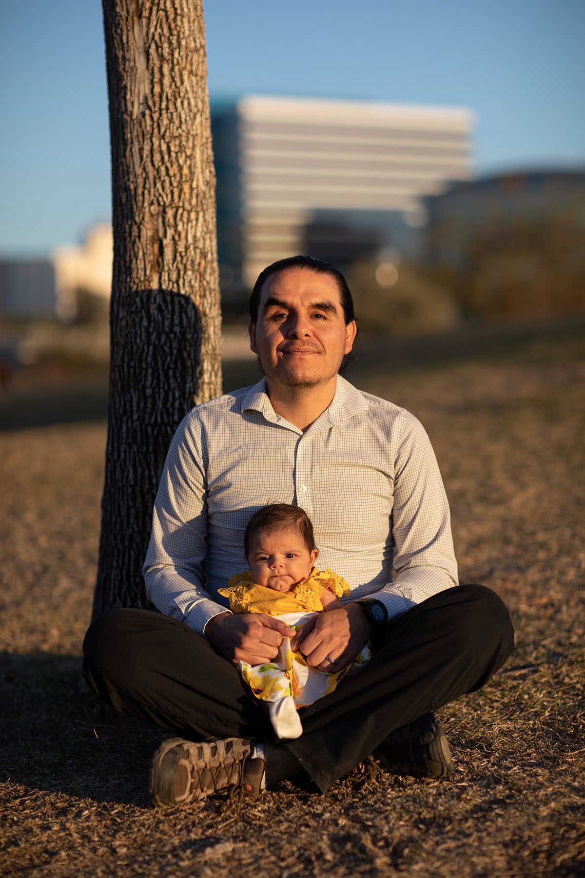 Sen. Juan Mendez holds his daughter as he poses for a portrait with his daughter Nausicaa at Tempe Beach Park.