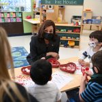 Vice President Kamala Harris speaks with children in a classroom.