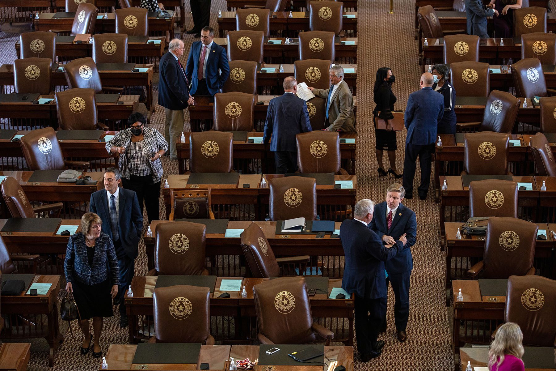 Texas state representatives gather in the House chamber at the Texas State Capitol.