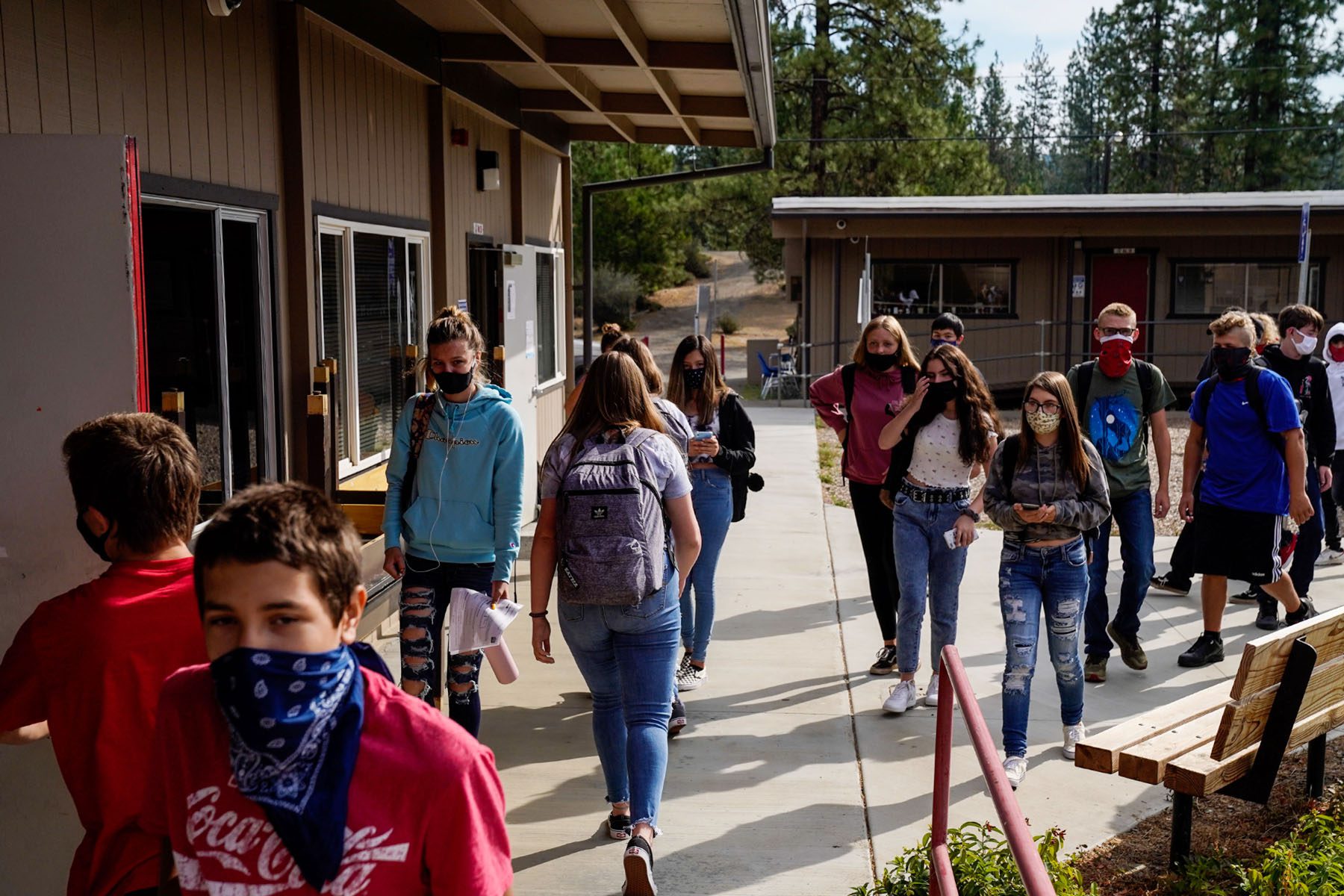 Students wearing masks walk to their next class.