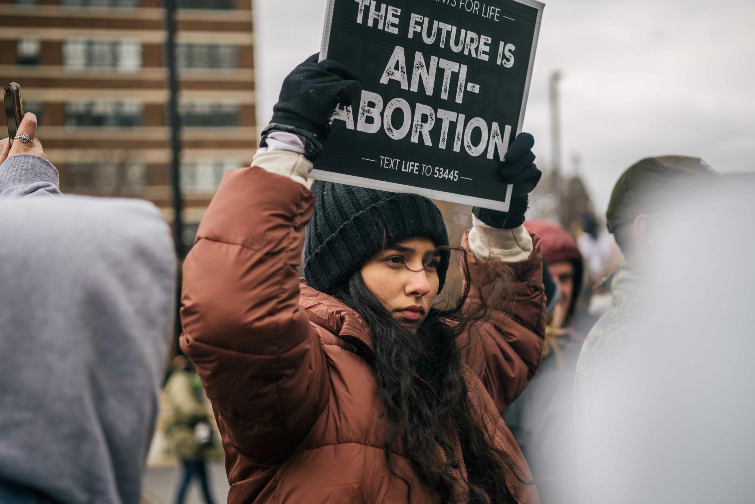 A woman holds a sign that reads "The Future is Anti-Abortion" during a rally.