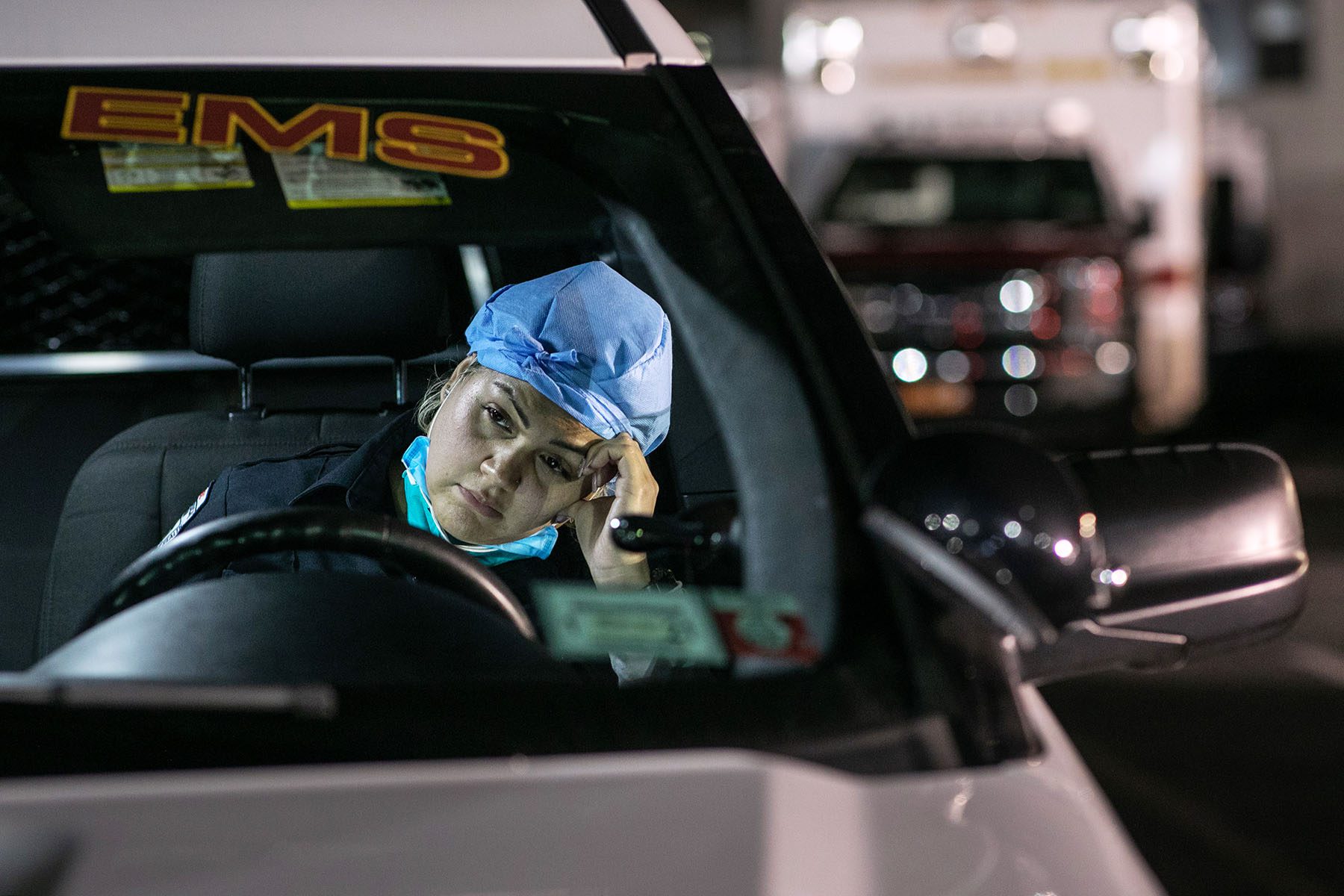 A paramedic fills out reports in her car.