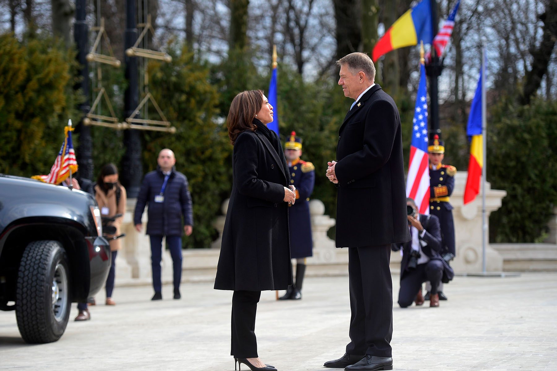 Kamala Harris and Romanian President Klaus Iohannis speak as she arrives in Bucharest.