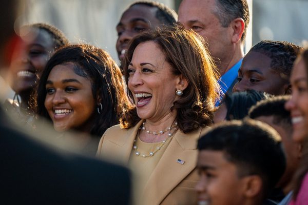 Vice President Kamala Harris smiles as she takes a picture with students.