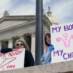 Abortion rights demonstrators hold signs at the Oklahoma state Capitol. One reads 