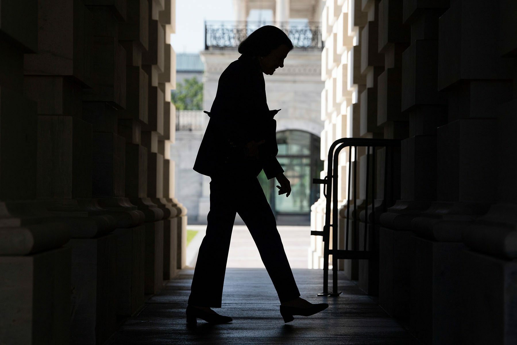 The silhouette of Sen. Dianne Feinstein is seen as she enters the Capitol.
