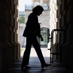 The silhouette of Sen. Dianne Feinstein is seen as she enters the Capitol.