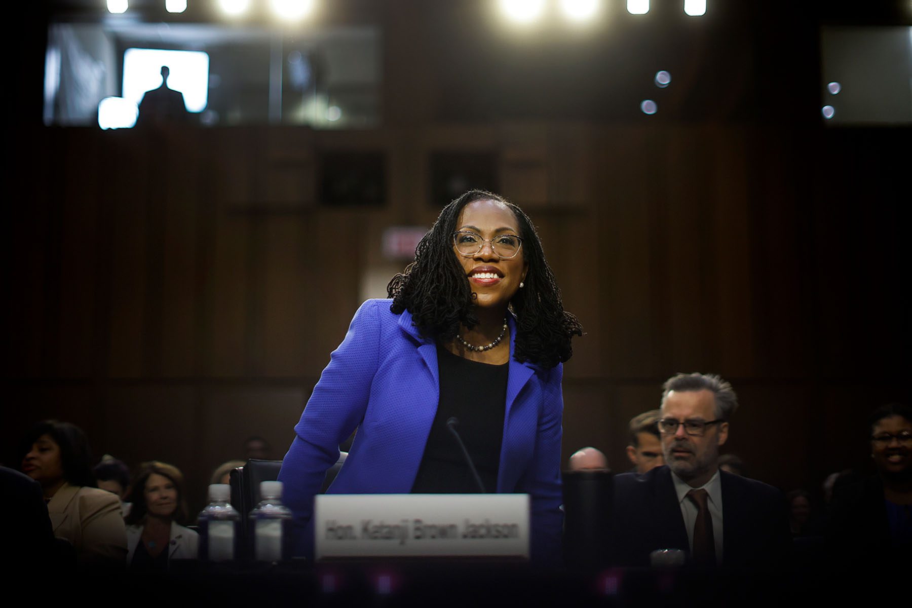 Judge Ketanji Brown Jackson smiles as she arrives at her confirmation hearing.