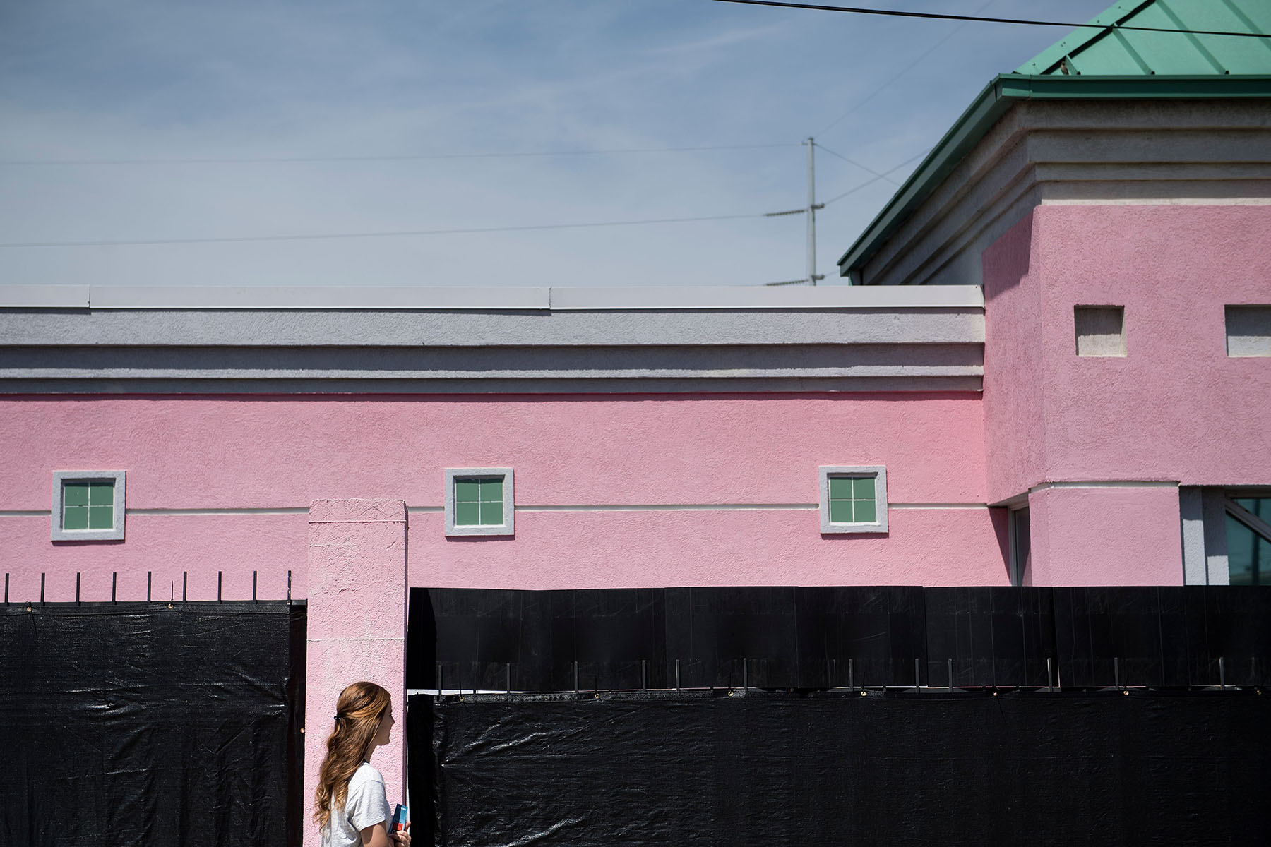 An anti-abortion rights activist stands in front of the last abortion clinic in Mississippi. She is holding pamphlets.