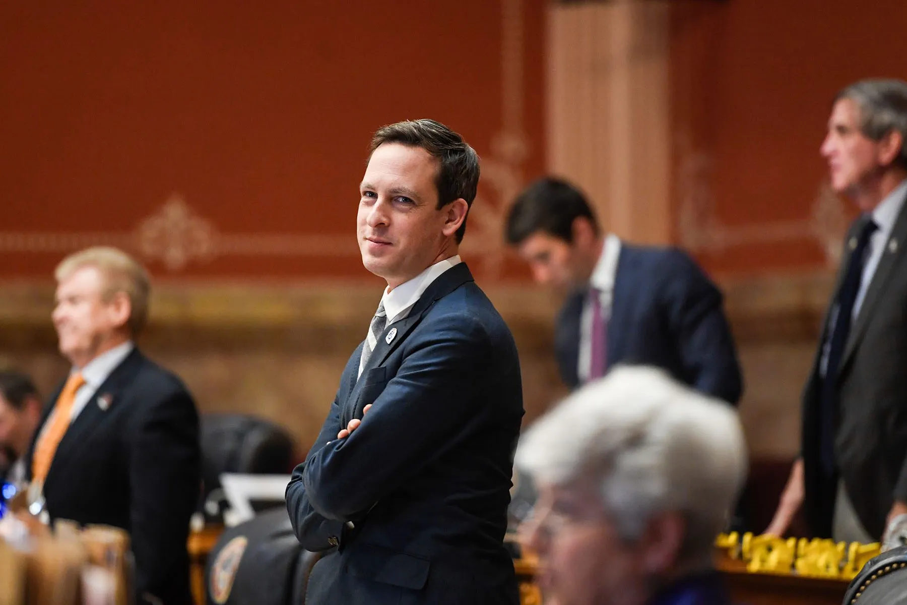 Sen. Stephen Fenberg stands and smiles at the Colorado State Capitol