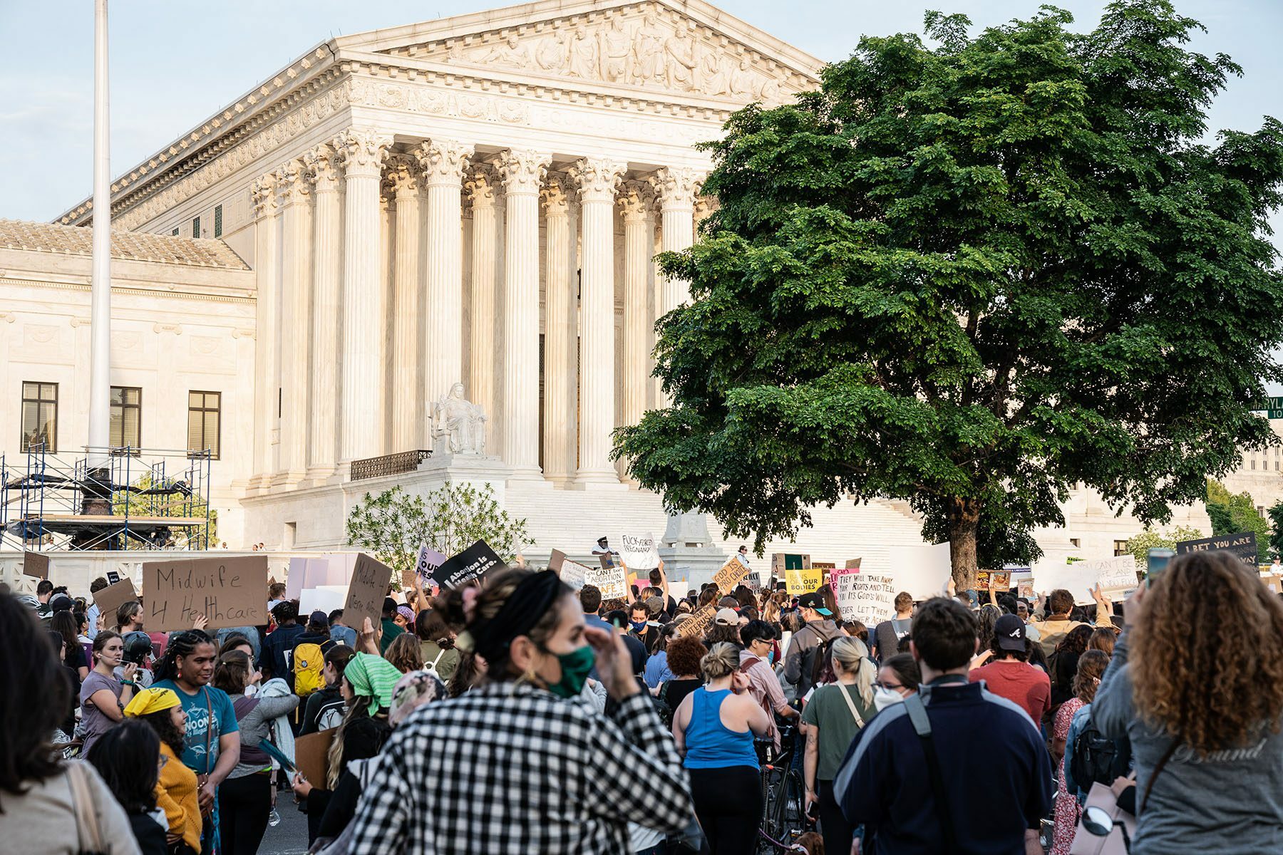 Crowds are seen protesting in front of the Supreme Court.