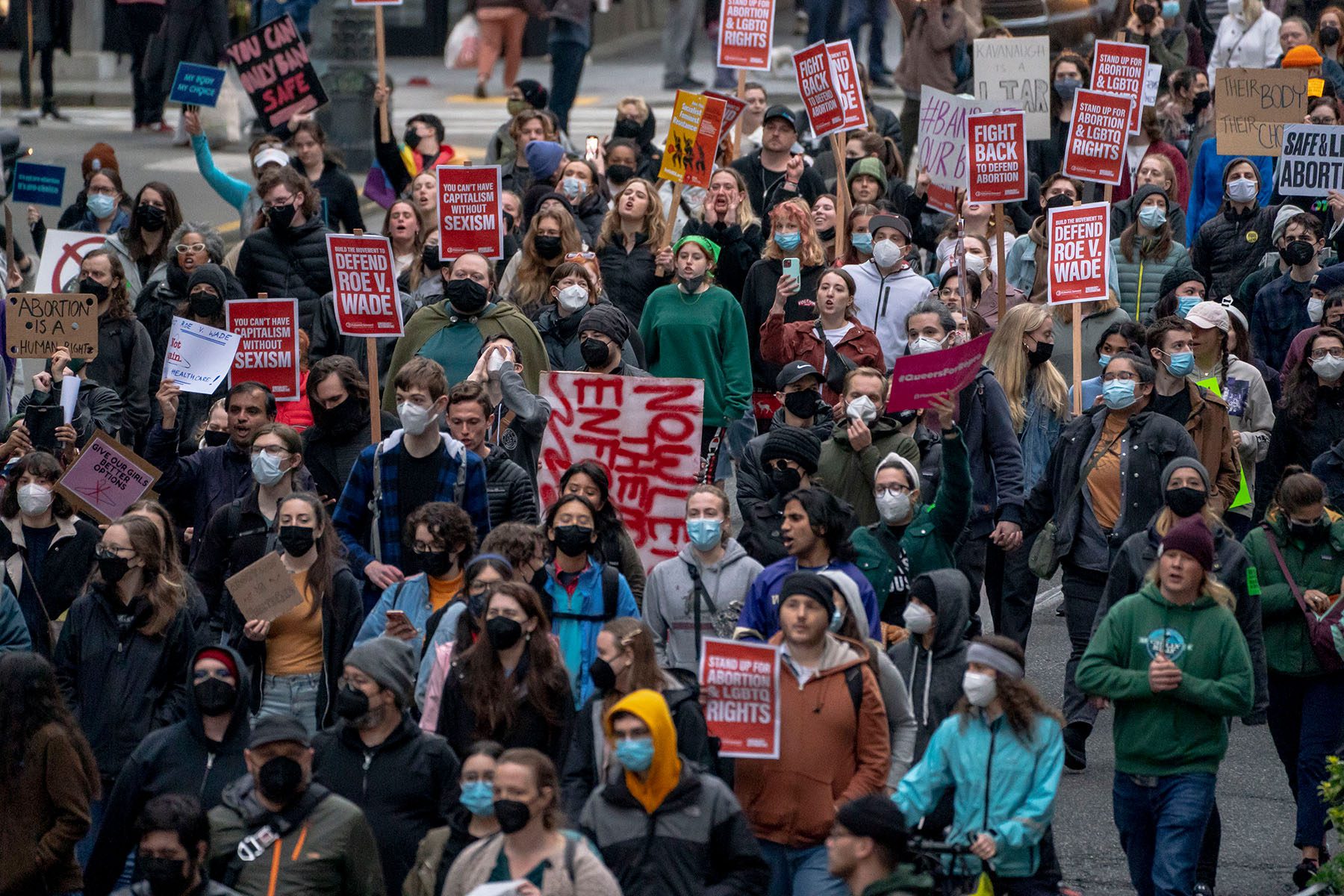 Demonstrators march through downtown Seattle. Signs read "Defend Roe v. Wade" and "Fight Back to Defend Abortion."