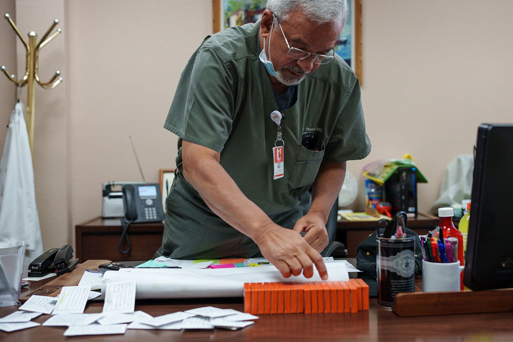 Dr. Franz Theard in his office, preparing doses for Mifestrone on his desk.