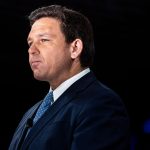 Ron DeSantis looks solemn on stage at the Conservative Political Action Conference.