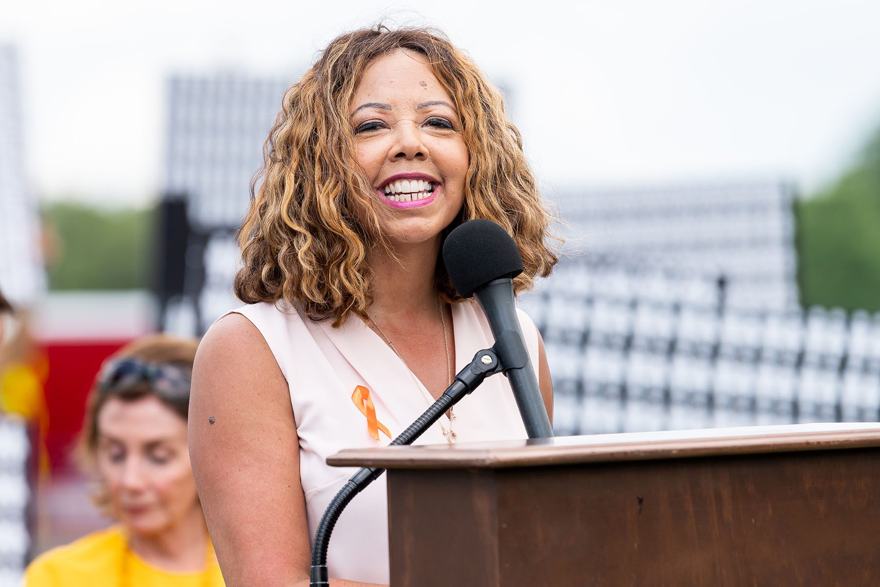 Lucy McBath smiles from a podium as she speaks.