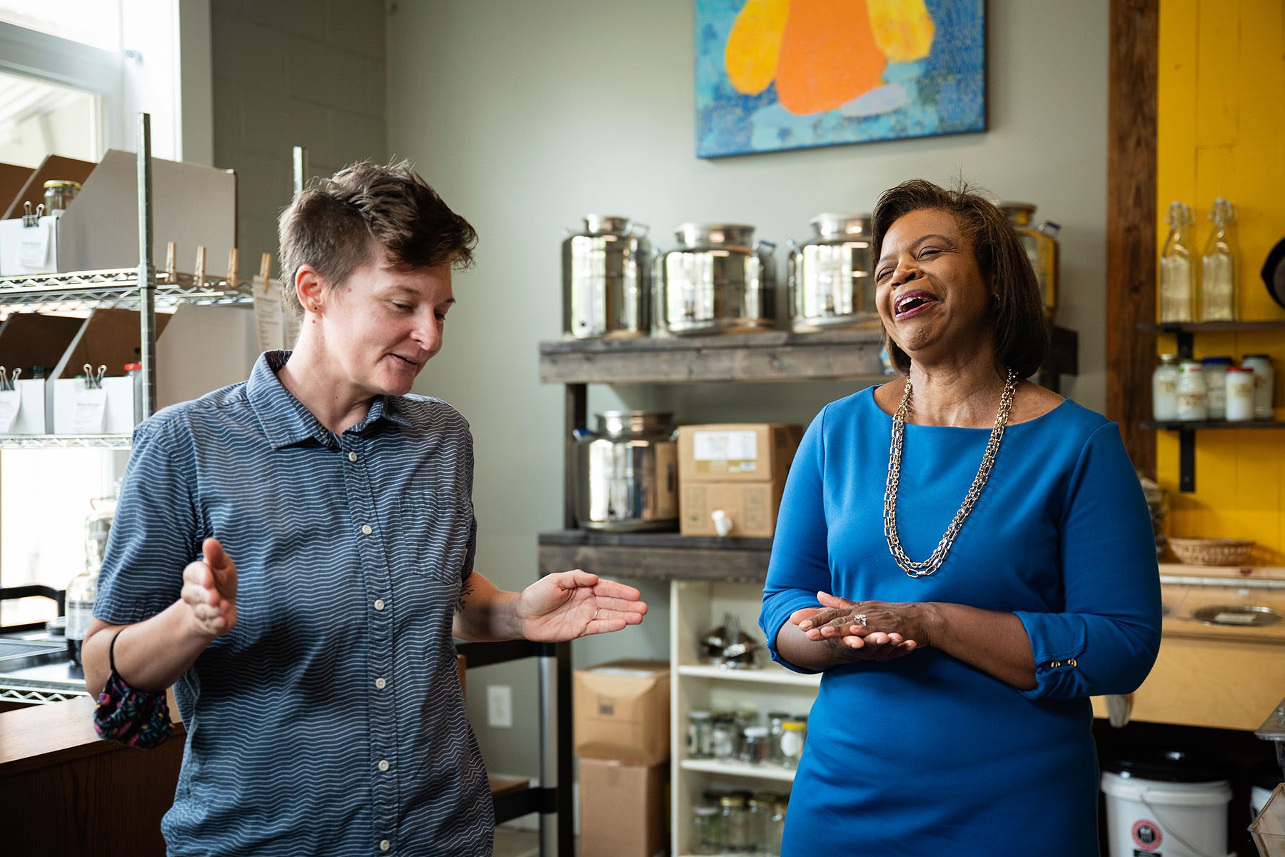 Cheri Beasley shares a laugh with the owner of Part & Parcel while visiting the grocery store.