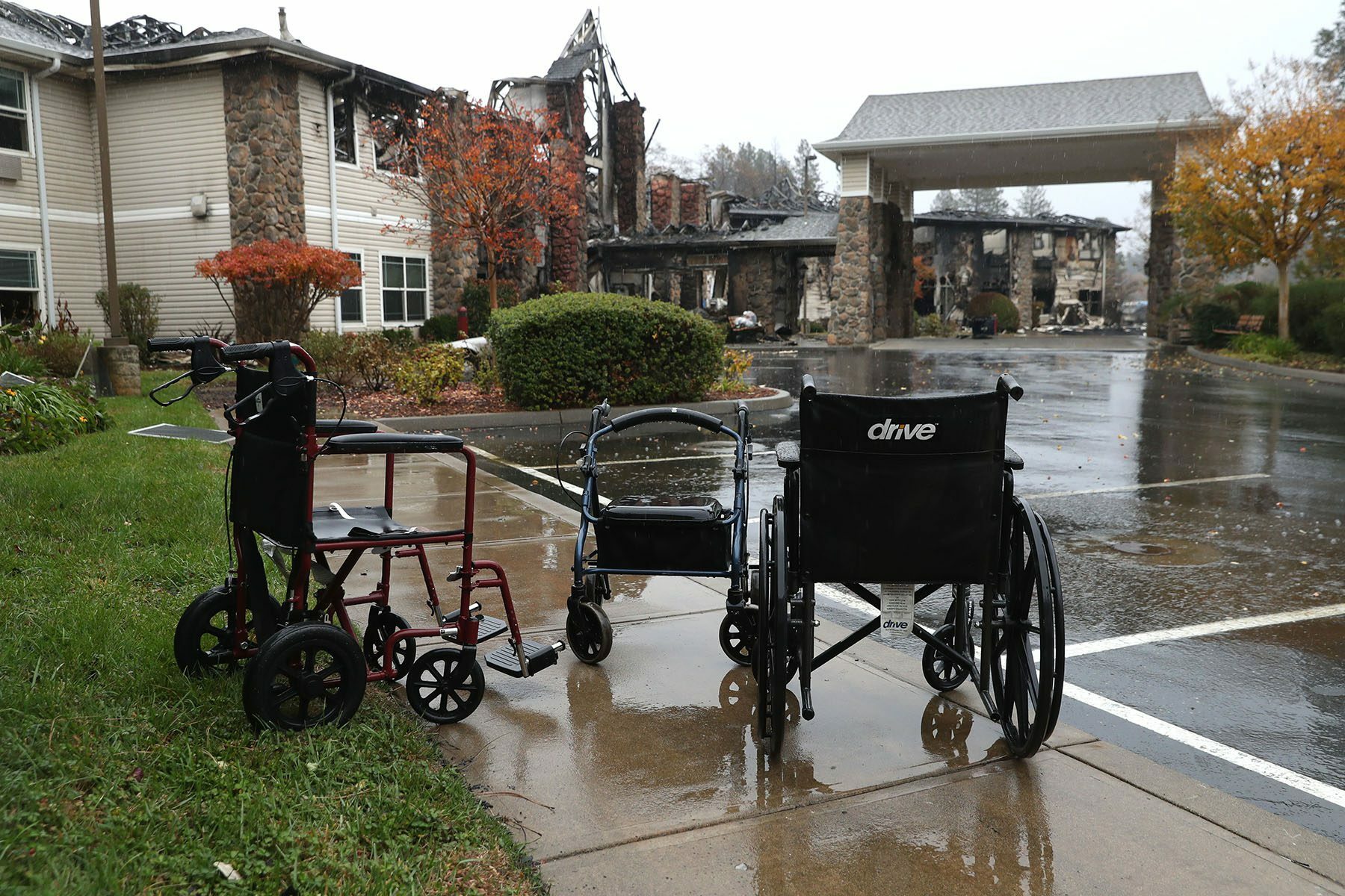 Empty wheelchairs sit in front of a senior living facility that was destroyed by the Camp Fire.