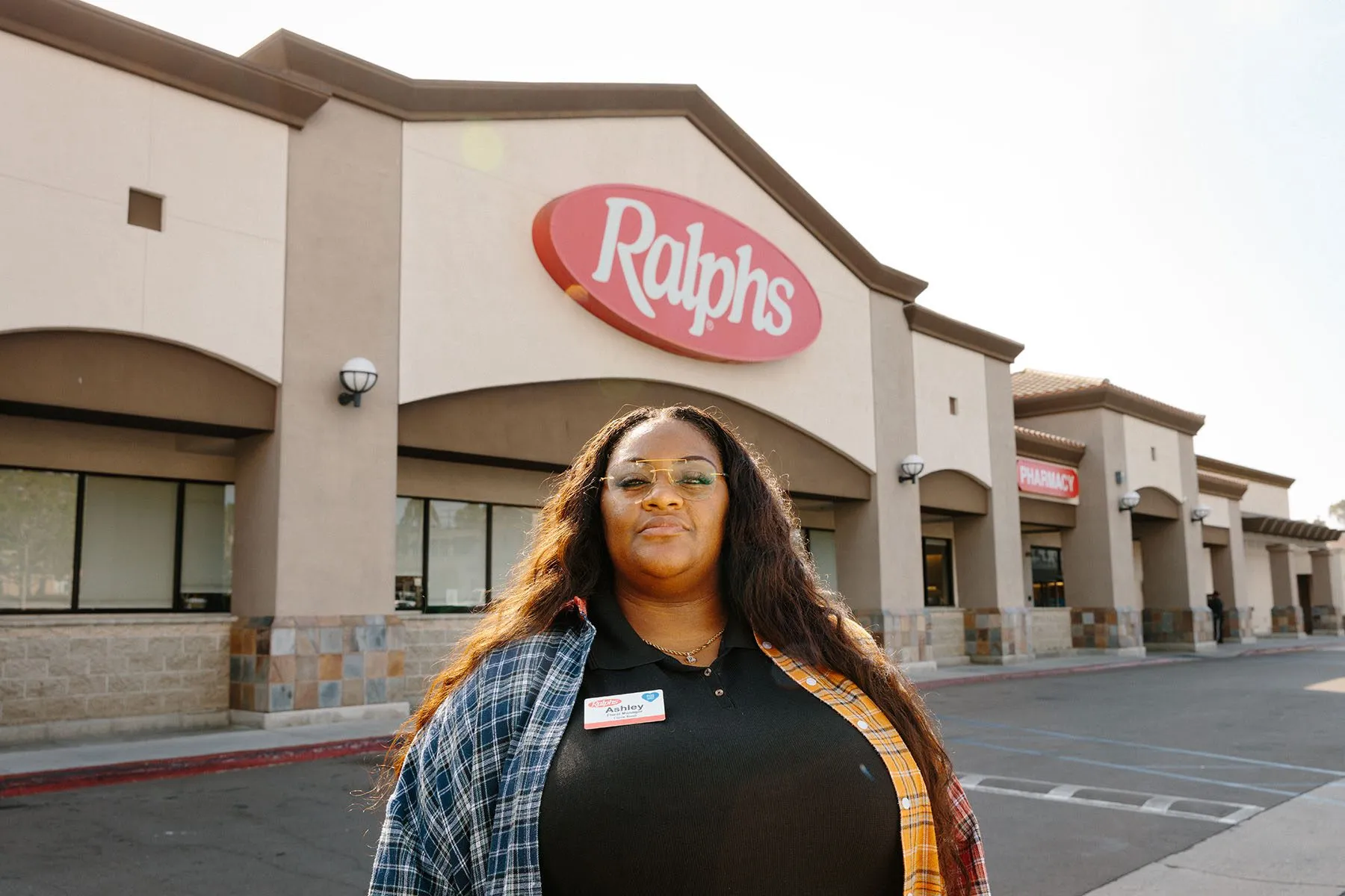 Ashley Manning poses for a portrait in front of the Ralphs grocery story where she works.