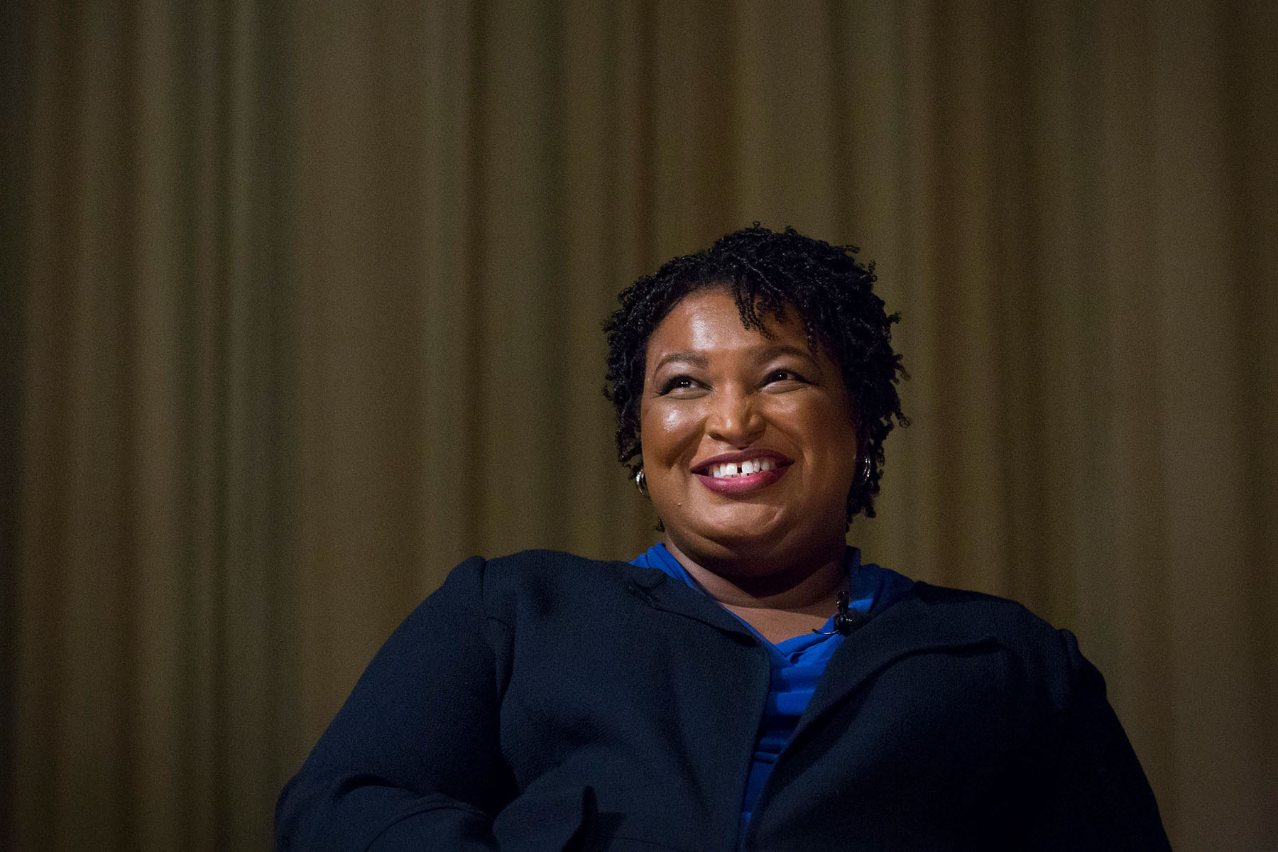 Stacey Abrams smiles as she looks up during a conversation with a former advisor to President Obama in Atlanta in 2019.