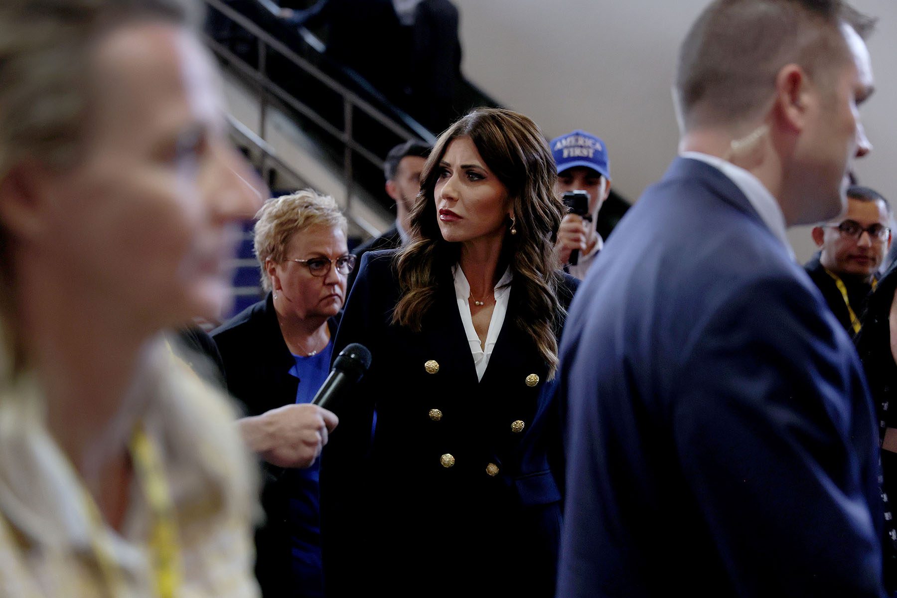 Kristi Noem attends the Conservative Political Action Conference. She is seen walking as reporters try to ask her questions.
