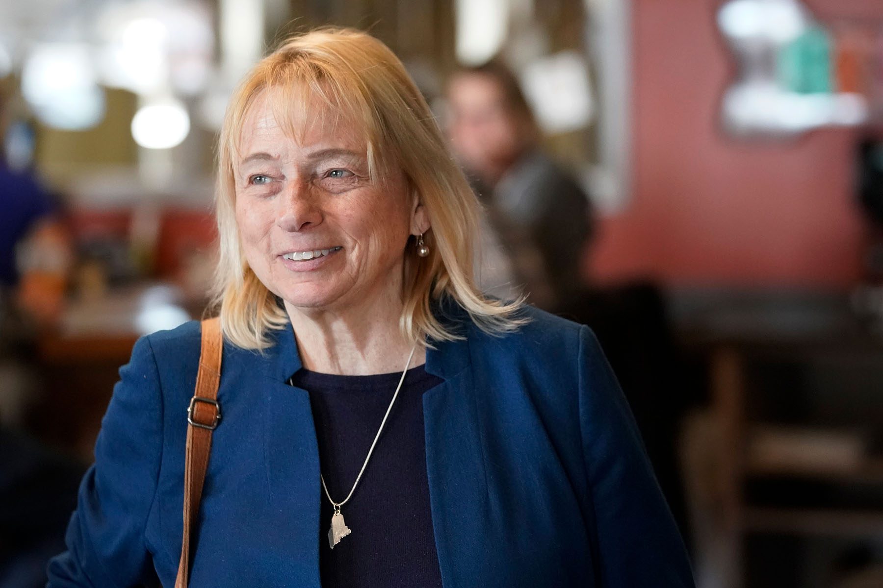 Janet Mills talks with patrons at Sebago Brewing Co. in Gorham, Maine