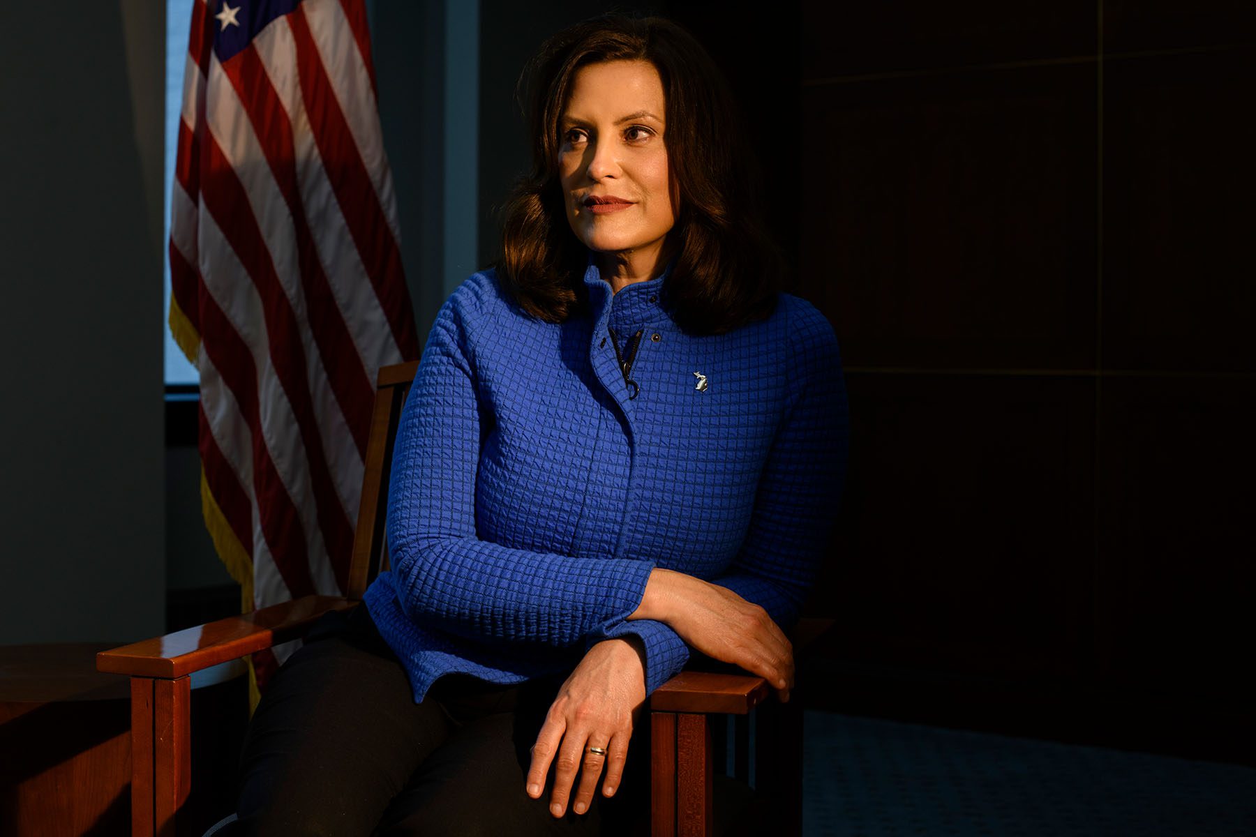 Gretchen Whitmer poses for a portrait near an American flag in the building where her office is located, in Lansing, Michigan in 2020.