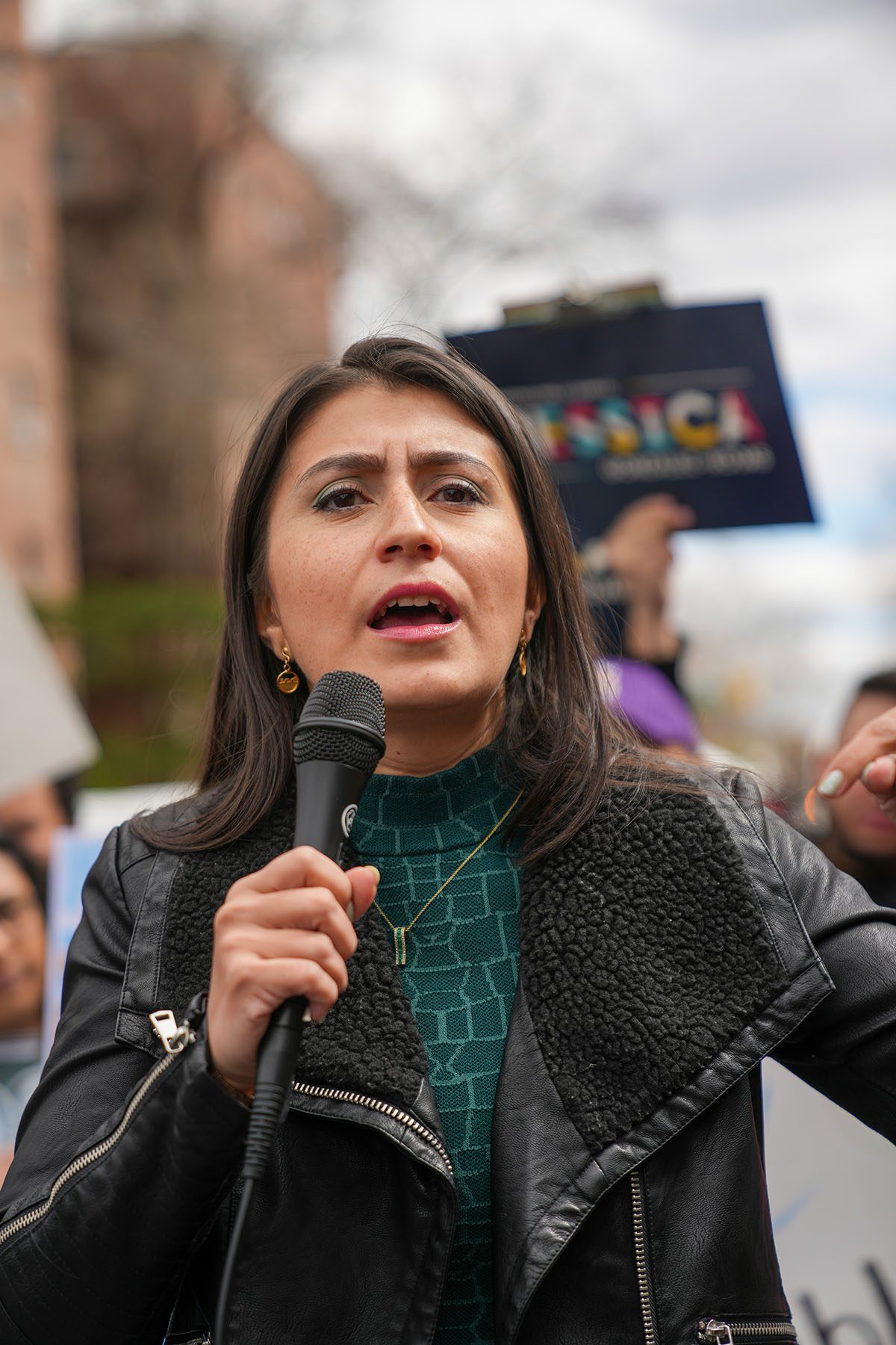 New York State Sen. Jessica Ramos holds a microphone at a campaign event
