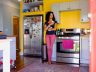 Malaika Ludman holds a mug in her kitchen as she poses for a portrait.