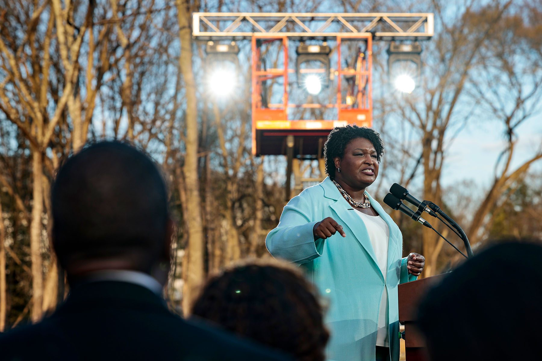 Stacey Abrams speaks on a podium during a campaign rally.