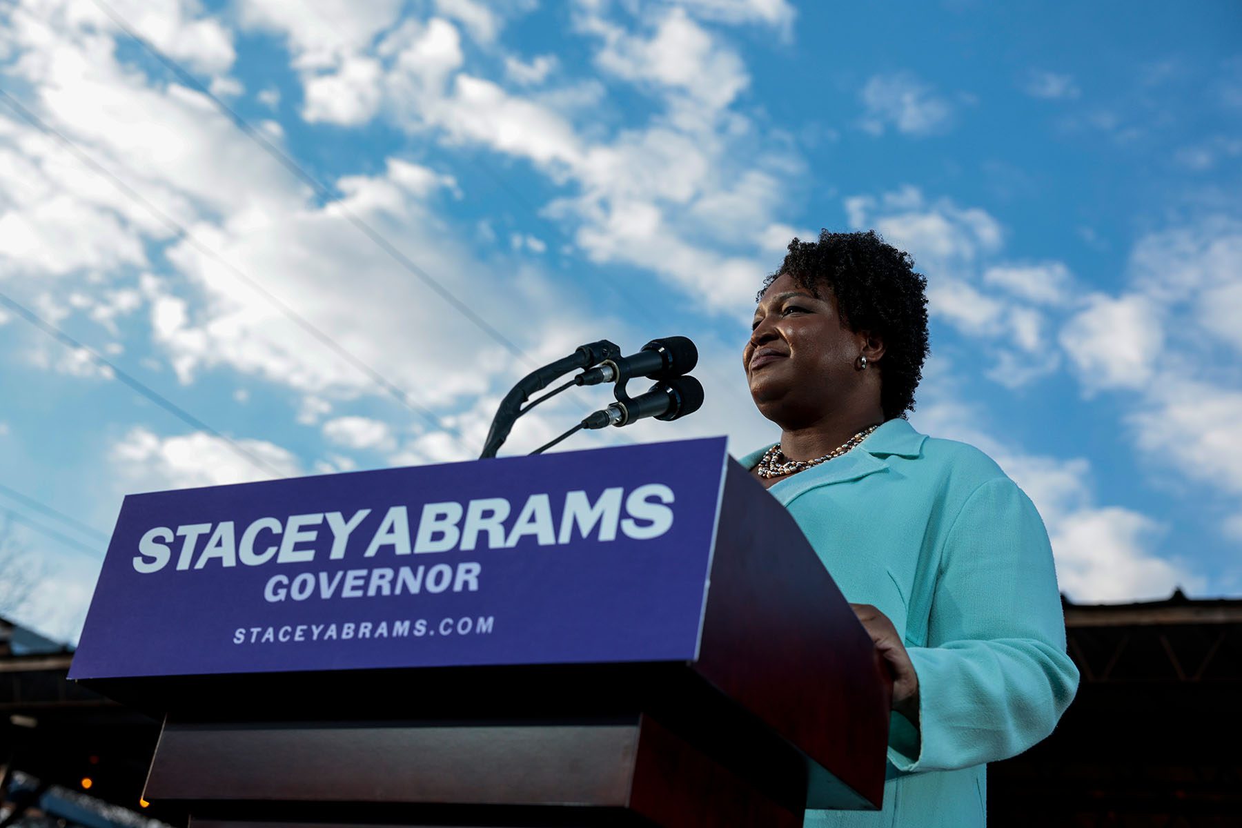 Stacey Abrams speaks from a podium during a campaign rally.