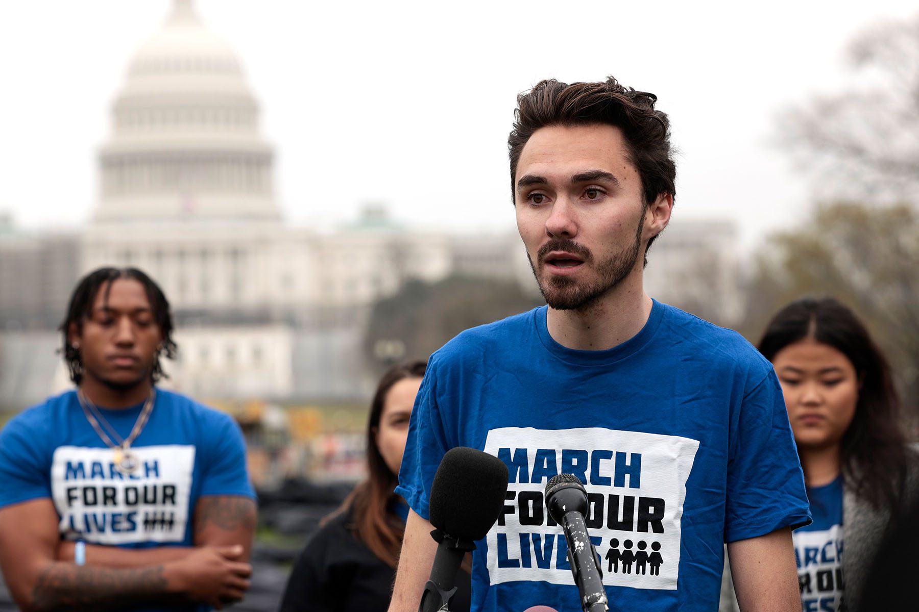 David Hogg speaks to reporters near the U.S. Capitol. He is wearing a "March for Our Lives" t-shirt.
