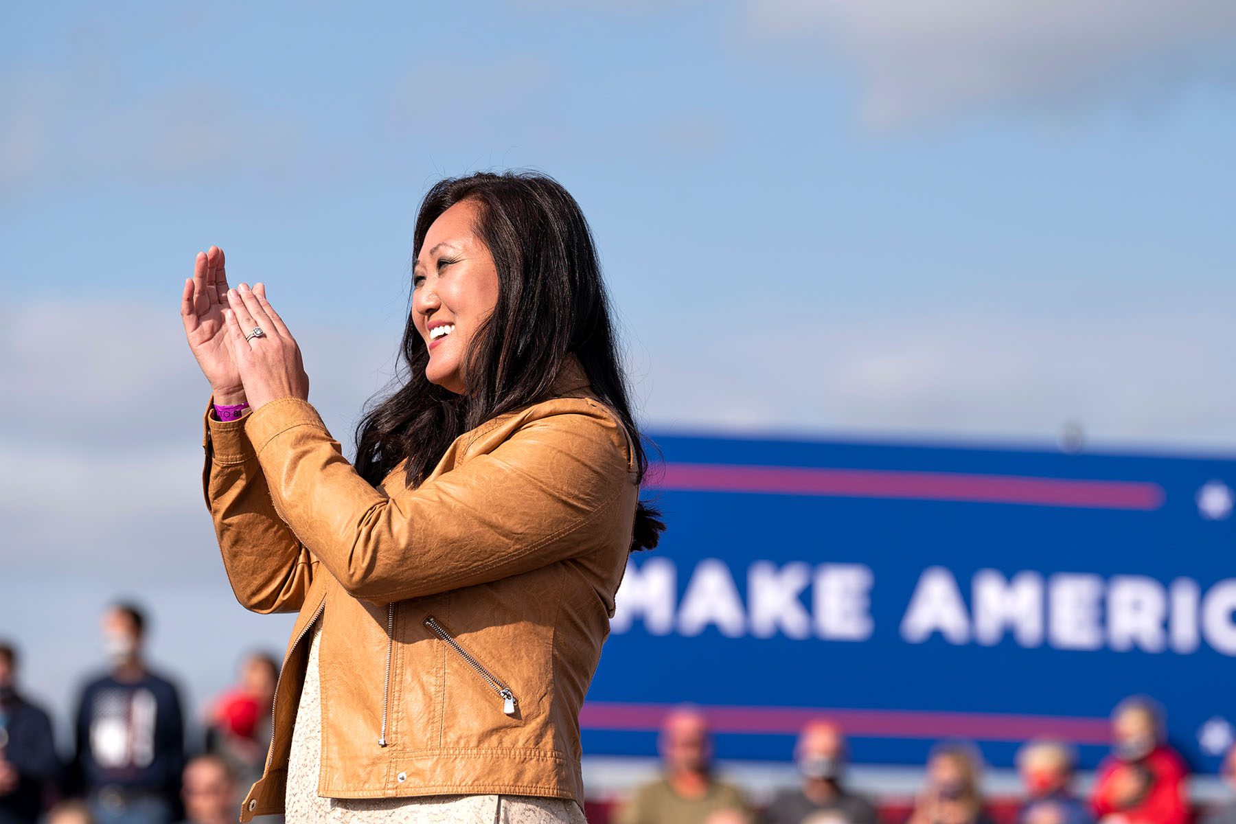 Jennifer Carnahan claps and smiles at a rally for President Trump.