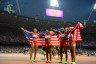 Carmelita Jeter, Allyson Felix, Tianna Madison and Bianca Knight celebrate their win by waving U.S. Flags