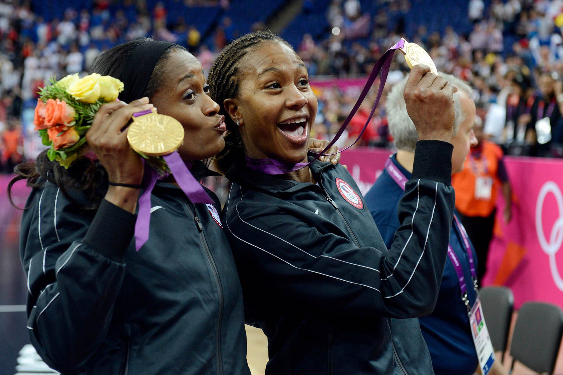 Tamika Catchings and teammate Swin Cash pose with their gold medals.