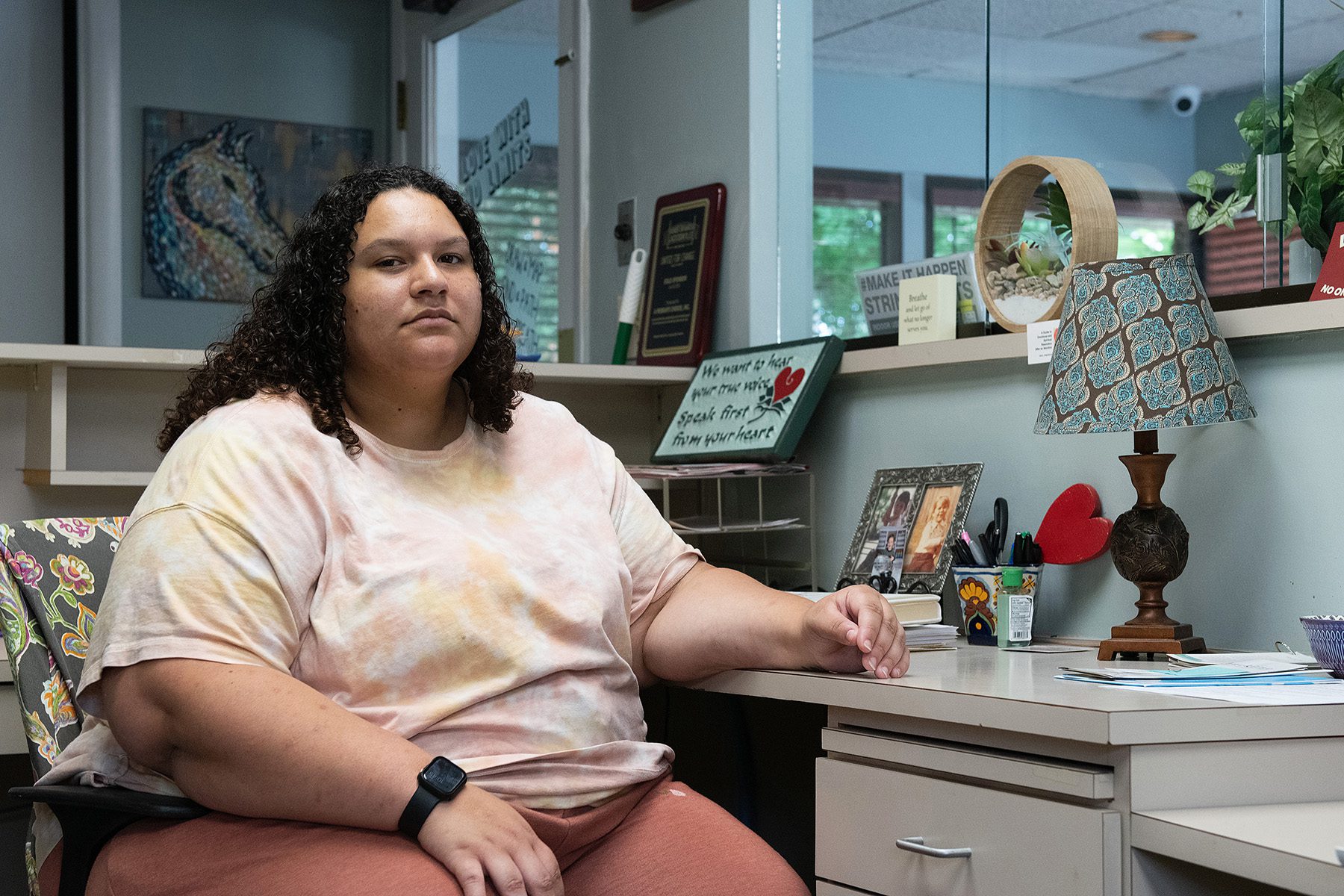 Portrait of Gabby Long sitting at her desk at the clinic.