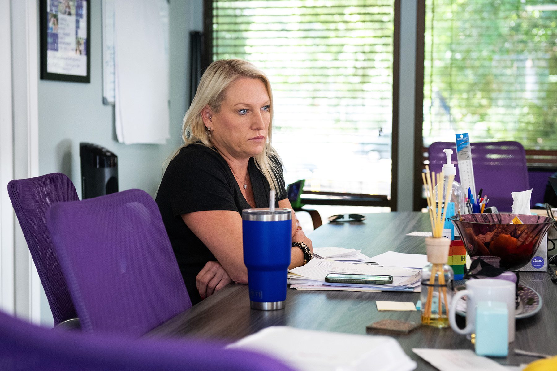 Kelly Flynn, CEO of A Woman’s Choice sits at a conference table as she meets with her team at the clinic.