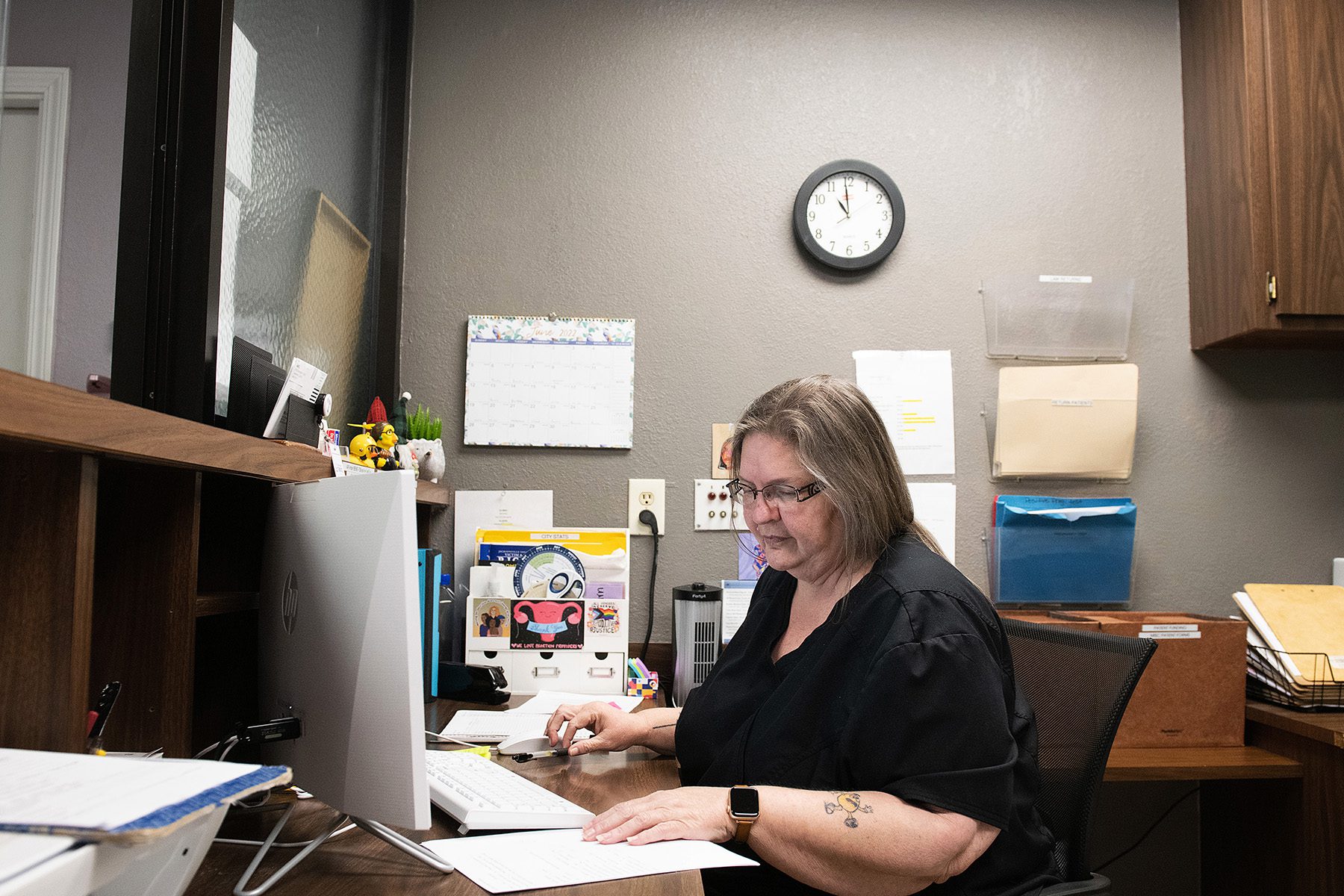 Brenda Timmons works on her computer at the Front Desk.