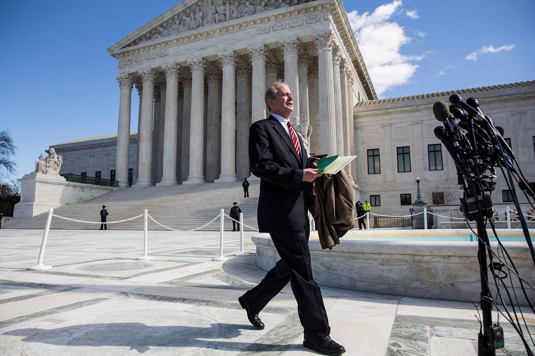 Clarke Forsythe walks towards microphone as he prepares to speak to the media in front of the Supreme Court building.