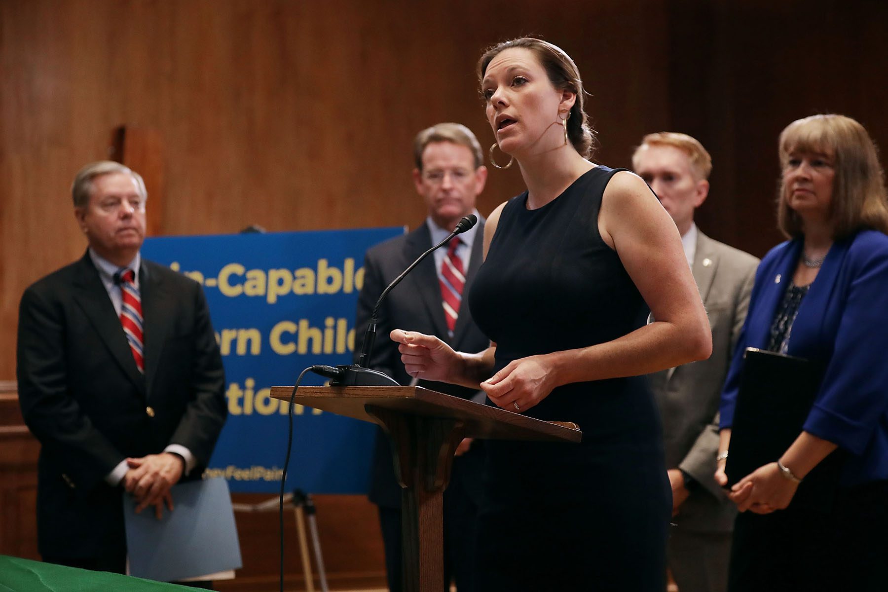 Catherine Foster speaks at a small podium during a news conference.