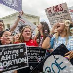 Anti-abortion activists celebrate in response to the Dobbs v. Jackson Women's Health Organization ruling in front of the U.S. Supreme Court.