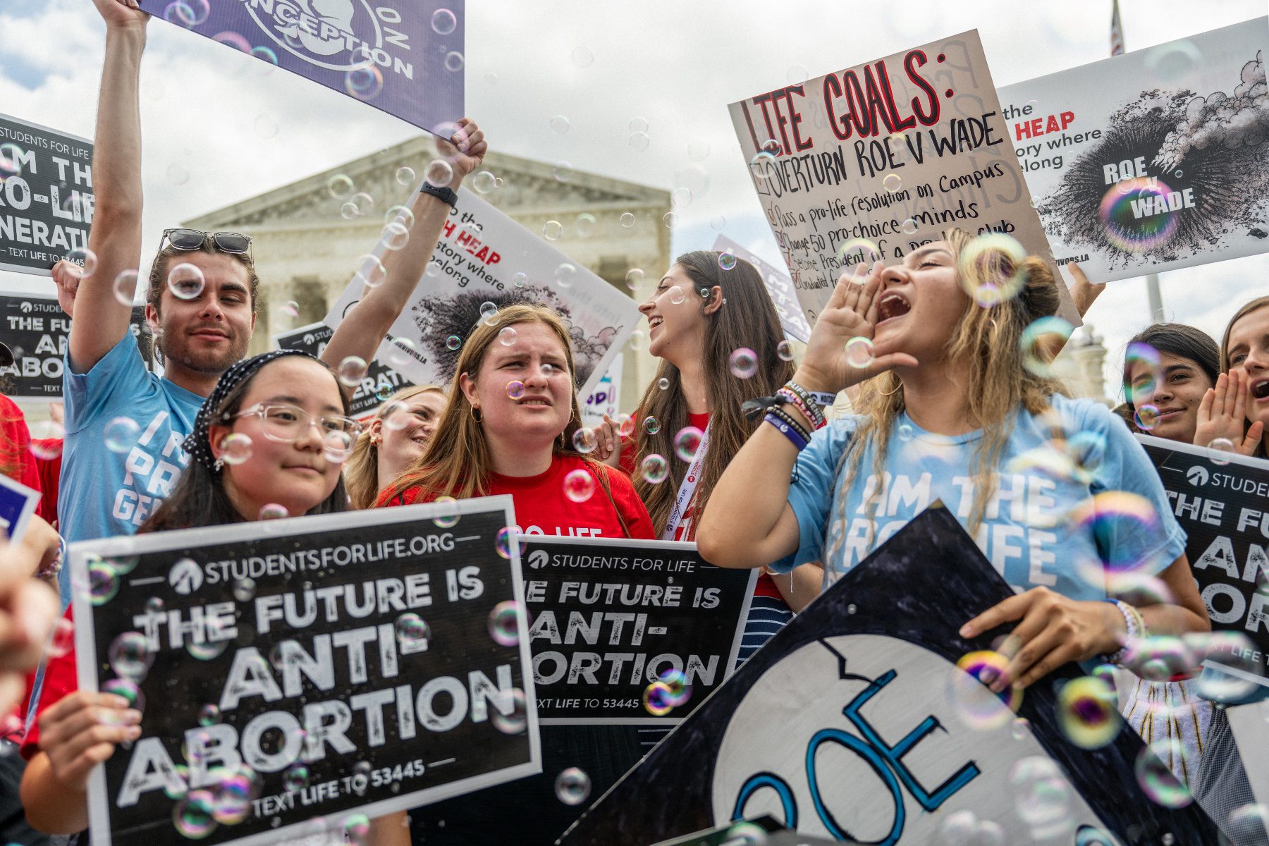 Anti-abortion activists celebrate in response to the Dobbs v. Jackson Women's Health Organization ruling in front of the U.S. Supreme Court.