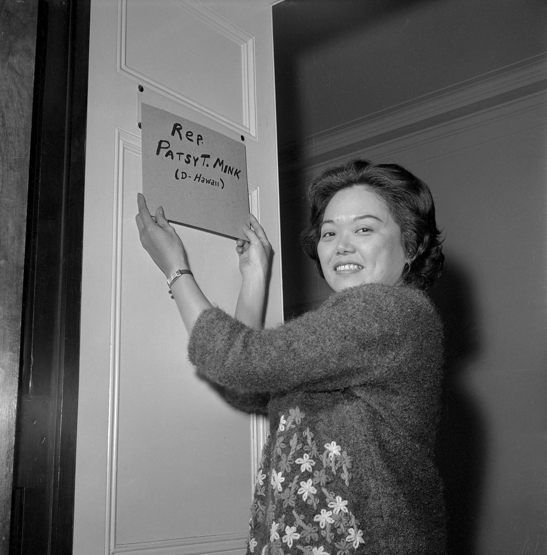 Rep. Patsy Mink holds a homemade plate that reads 