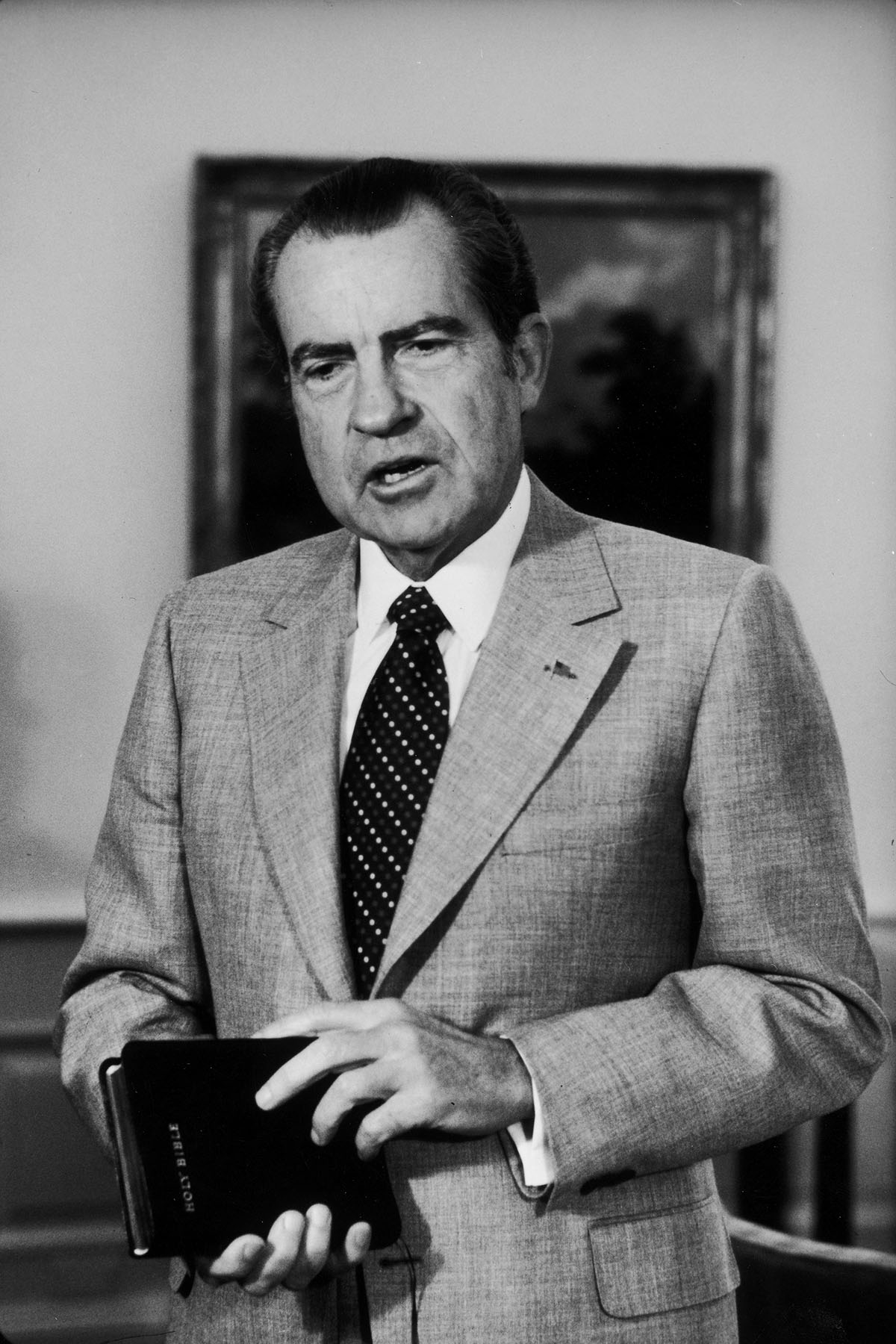 President Richard Nixon holds a bible at a swearing in ceremony.