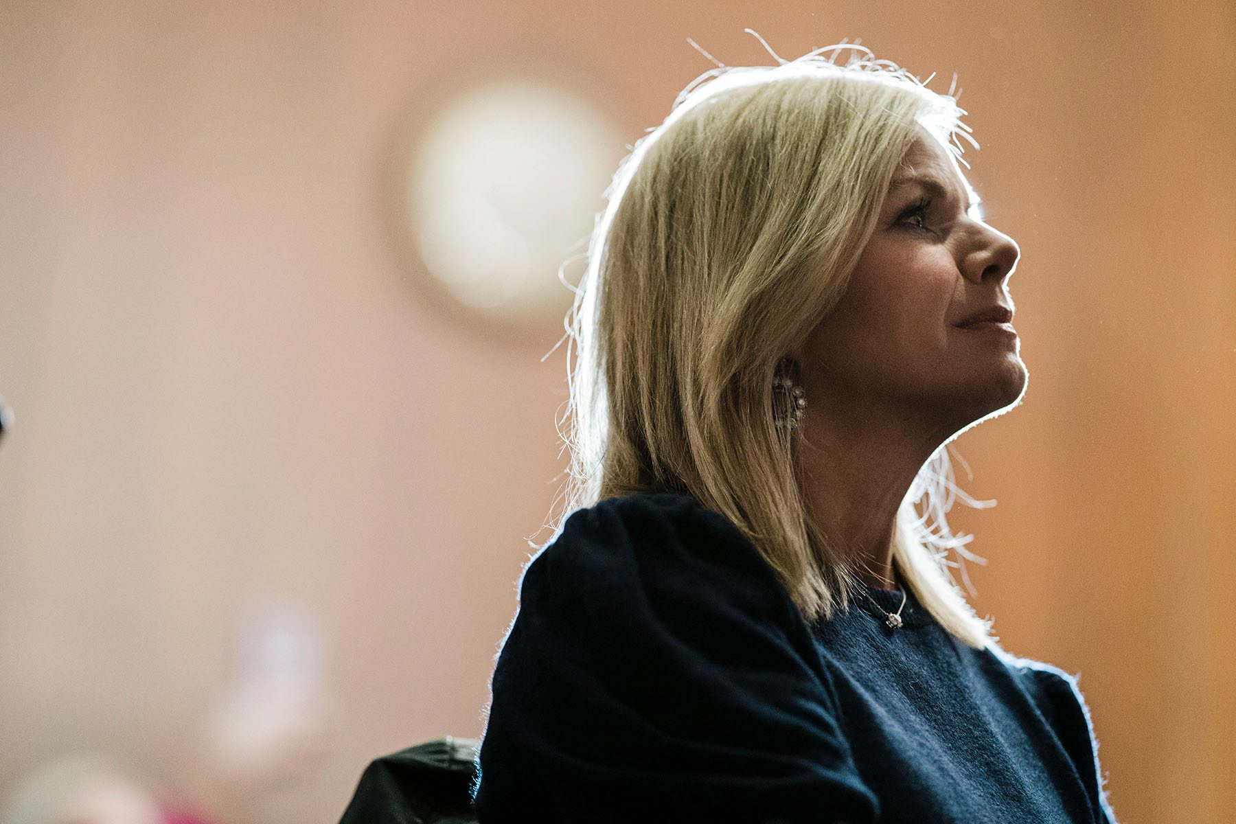 Former Fox News anchor Gretchen Carlson looks emotional during a news conference.