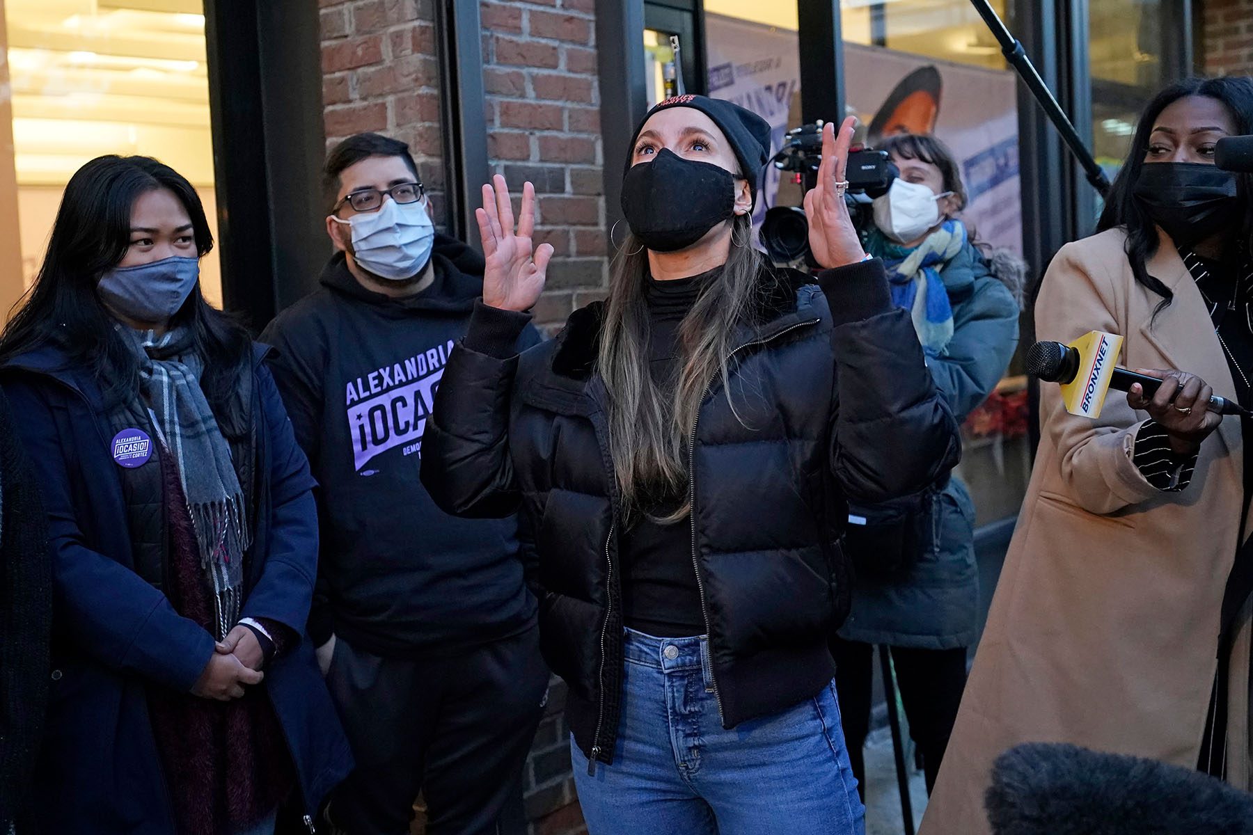 Sen. Biaggi speaks to members of Rep. Alexandria Ocasio-Cortez's staff.