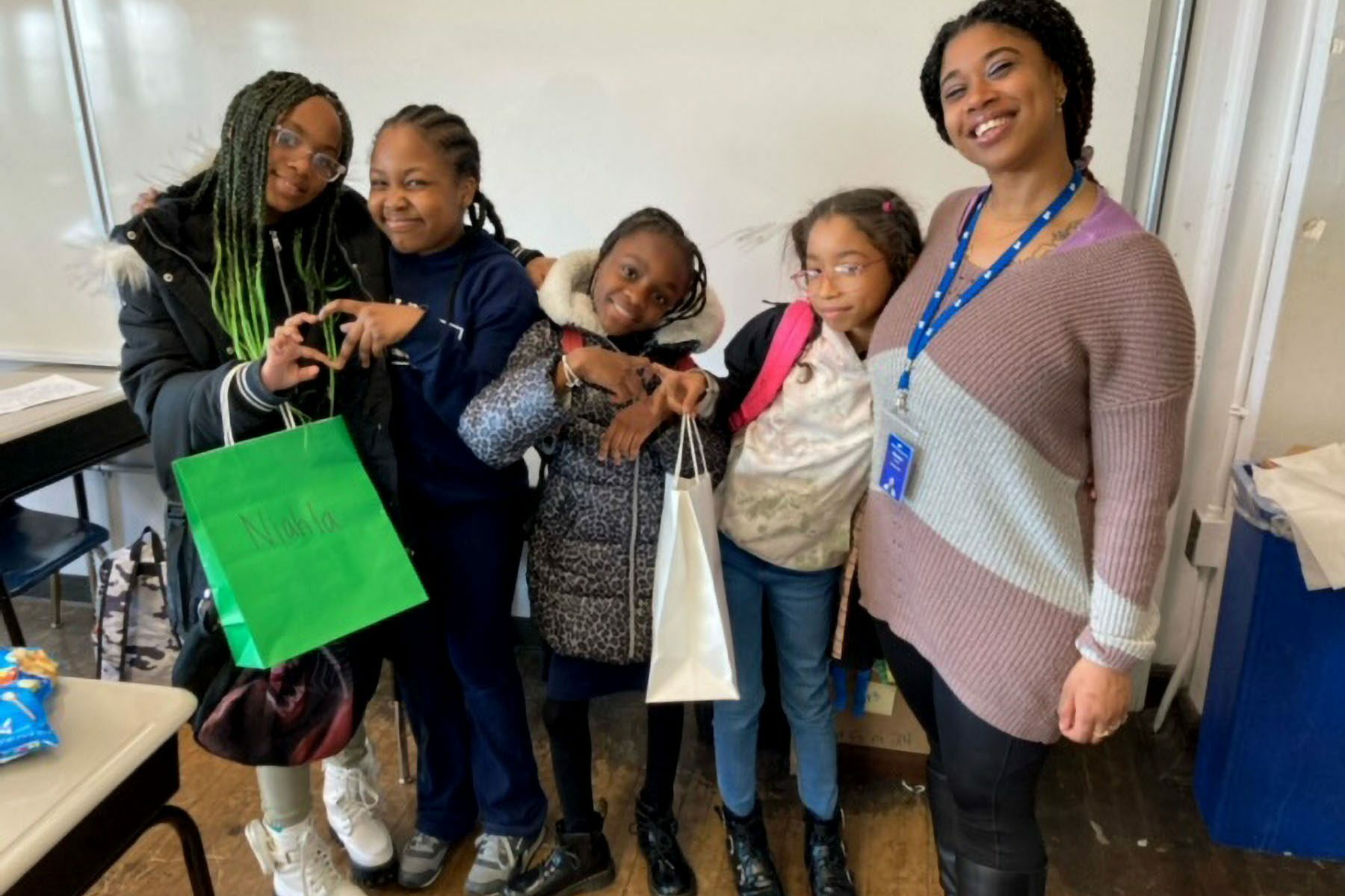 Atiyah Harmon poses for a picture with her students in a classroom